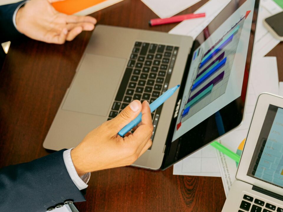 Free A Person in Black Suit Holding a Pen Stock Photo