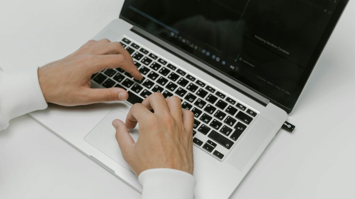 Free Hands on a Laptop Keyboard Stock Photo