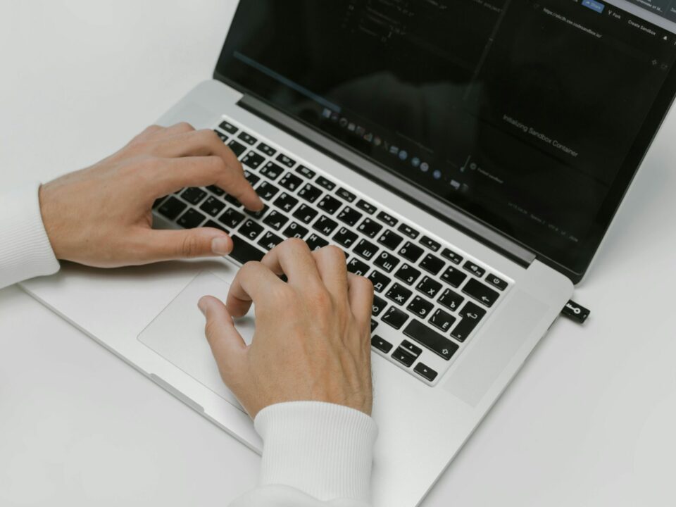 Free Hands on a Laptop Keyboard Stock Photo